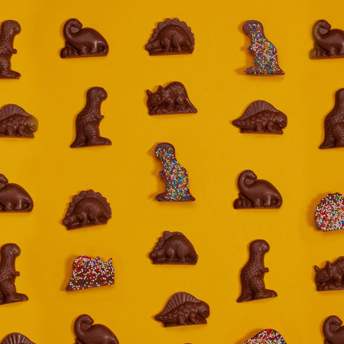 Luxury handmade chocolate dinosaurs topped with sprinkles